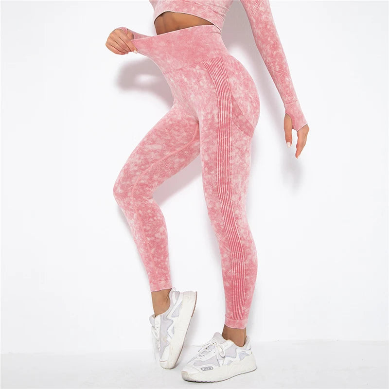 Person wearing pink tie-dye leggings and a matching top on a white background