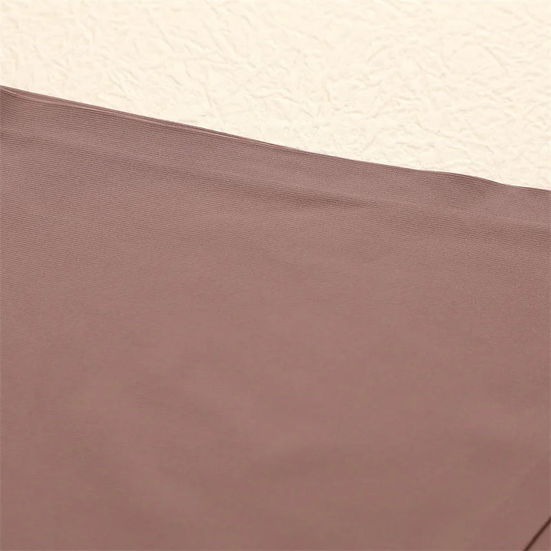 Close-up of brown fabric with a textured beige background