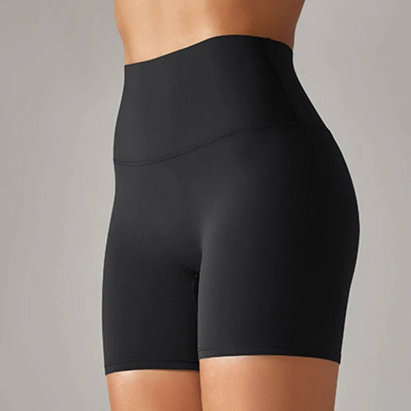 Black high-waisted shorts on a neutral background