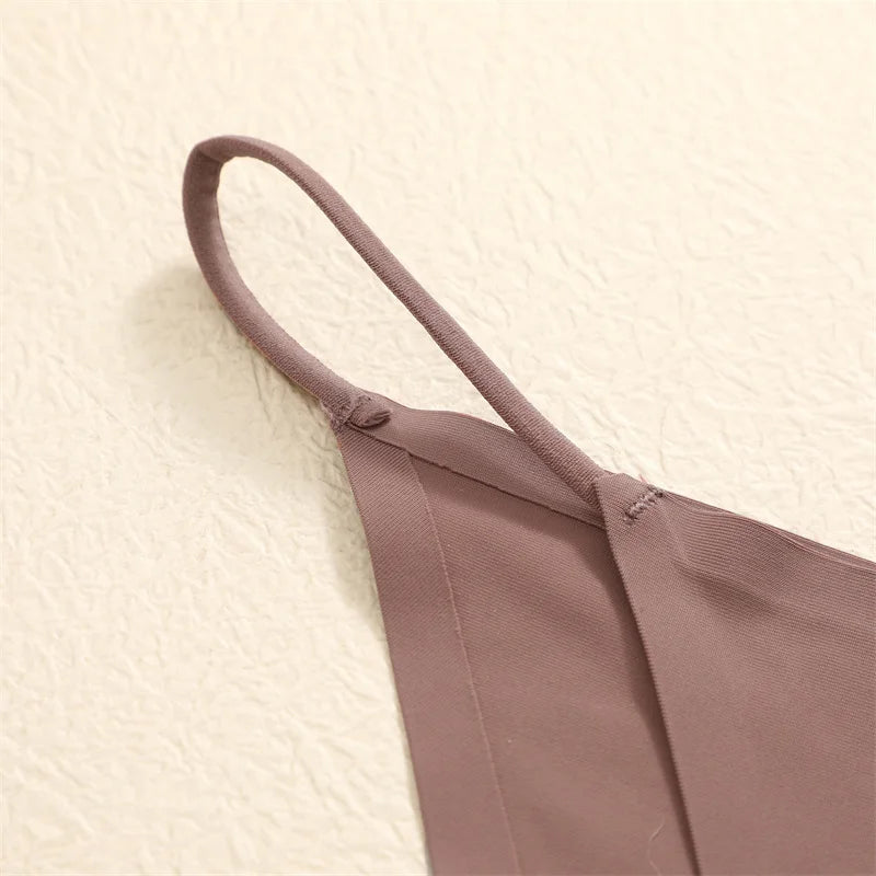 Brown bikini top on a textured beige surface