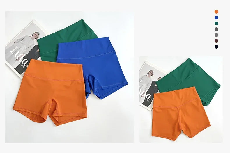 Two pairs of colorful shorts on a white background with magazine pages.