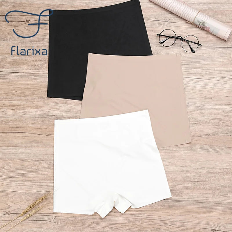 Black, beige, and white shorts on a wooden surface with 'Flarixa' branding.