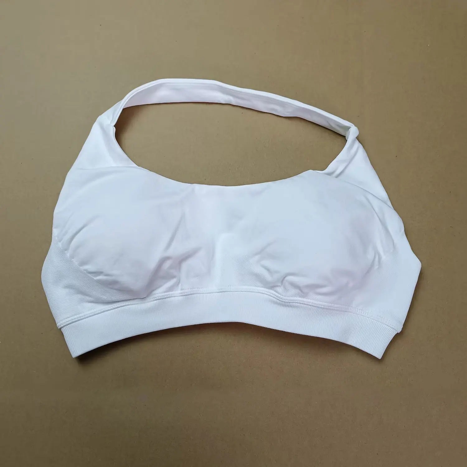 White sports bra on a brown background