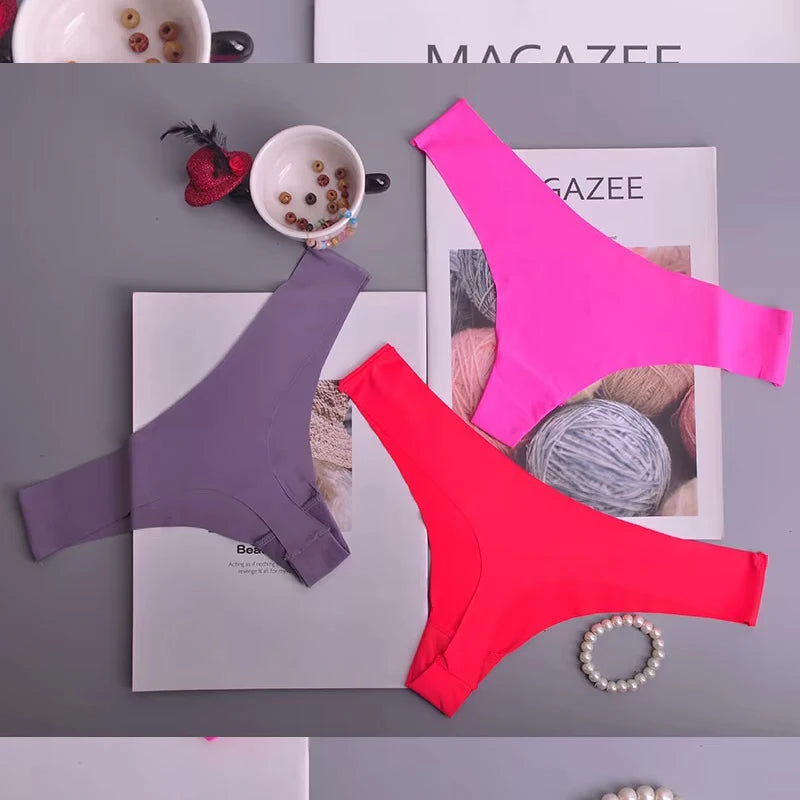 Three pairs of colorful underwear on a magazine with a blurred background