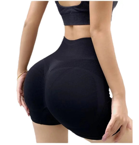 Black athletic shorts worn by a person on a white background
