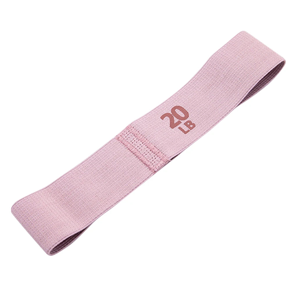 Pink resistance band with '20 lb' marking on a white background