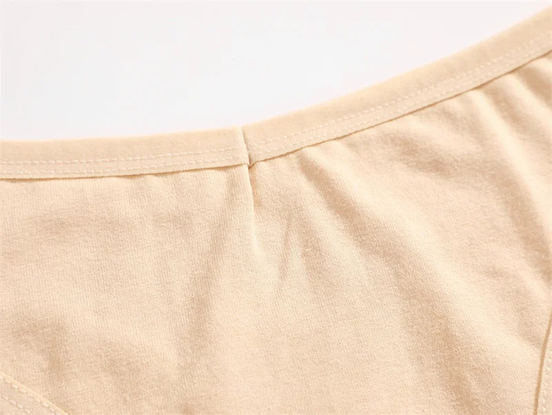 Close-up of beige womens underwear fabric with a plain background