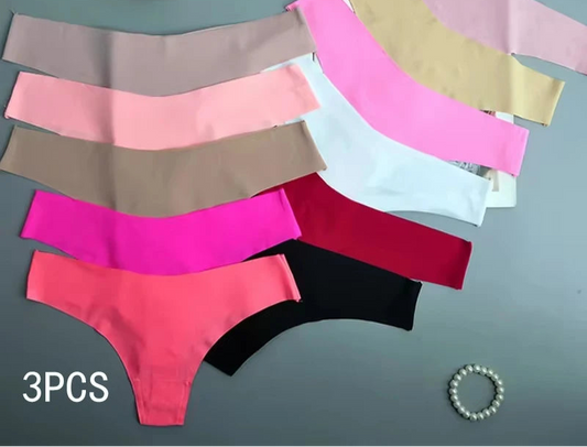 Set of colorful women's underwear on a gray surface 