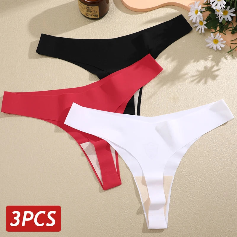 Three pairs of men's underwear in black, red, and white on a beige surface with flowers.