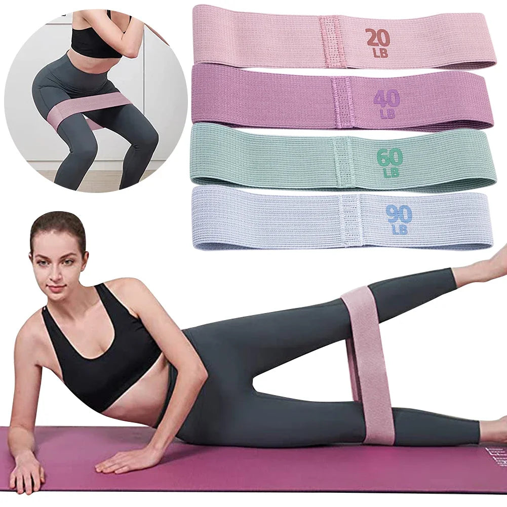 Woman exercising with resistance bands of different weights on a white background