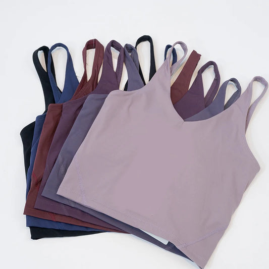 Stack of purple tank tops on a white background
